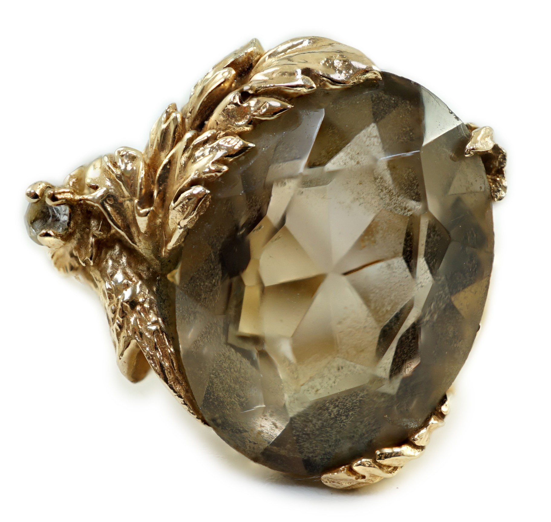 A 10k yellow metal, smoky quartz and white stone set dress ring, size M, gross weight 7.3 grams.